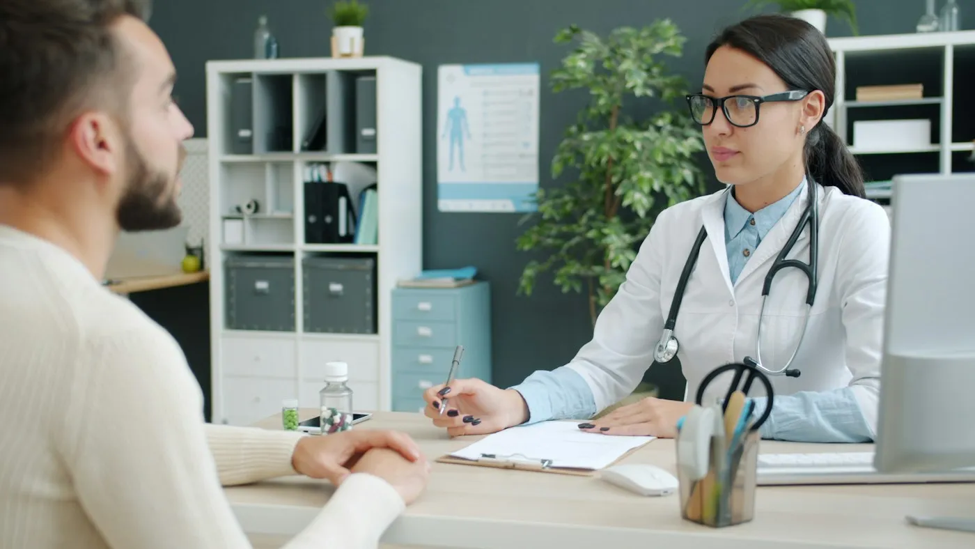 Clinician reviewing test results with a patient during a consultation